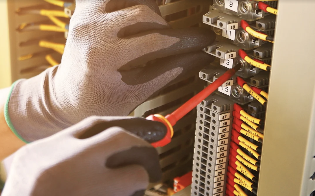 Electrician wiring a panel
